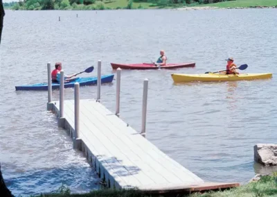 Regatta Dock Services Dock With Three People Kayaking In Lake Zoar