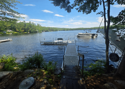Dock System With Stairs And A Pontoon Boat On A Lake.