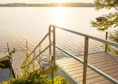 Aluminum Dock Stairs And Gangway On A Shoreline At Sunset.