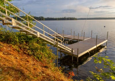 Aluminum Dock Stairs Connecting A Shoreline To A Floating Dock.